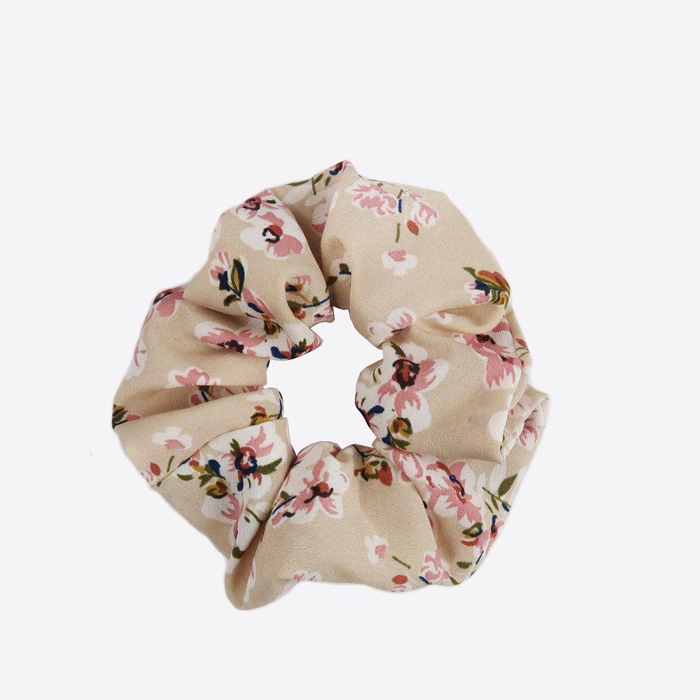 Sistie Scrunchie in cream color with flowers on it